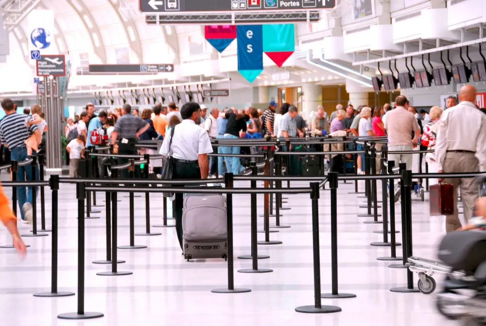 Crowd of people waiting in line at airport